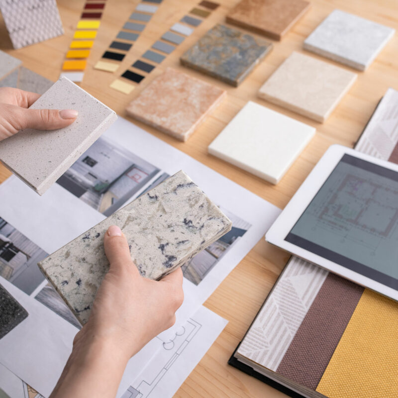 hands-young-female-designer-holding-two-samples-marble-tile-wooden-table-with-digital-tablet-photos-home-interior-etc